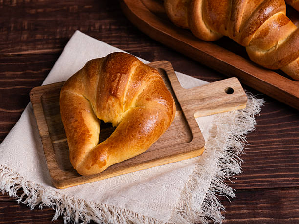 istock Golden Croissant on Rustic Wooden Board 2214407031