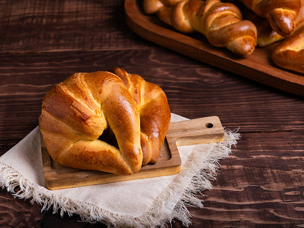 Golden Croissant on Rustic Wooden Board