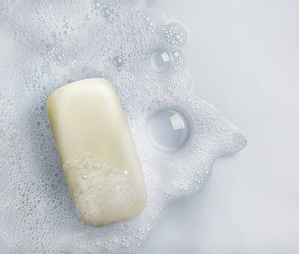 istock White soap bar and suds on a white background. 2214407176