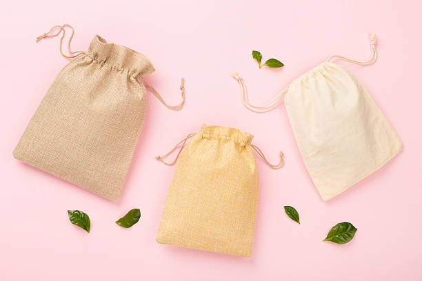 istock Small eco sacks on color background, top view 2214408853