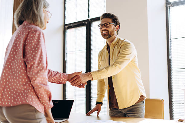 istock Business people shaking hands during meeting in modern office 2214412776