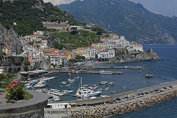 Sorrento, Italy - June 5, 2019: View from the sea of this picturesque Italian Mediterranean city, with old and colorful houses built on the side of a hill.