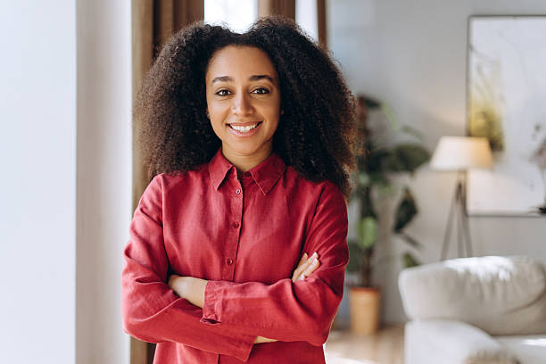 istock Confident young Latin manager smiling with folded arms in modern office 2214414839
