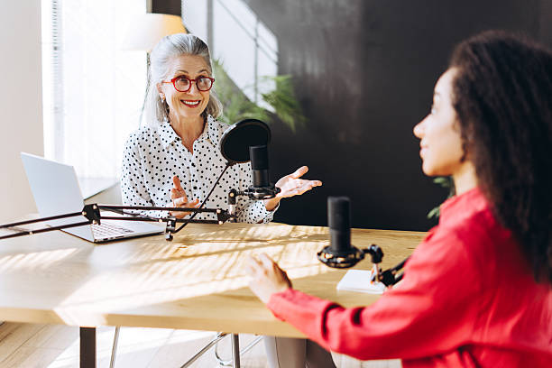 istock Radio hosts interviewing businesswoman in recording studio podcast 2214414853