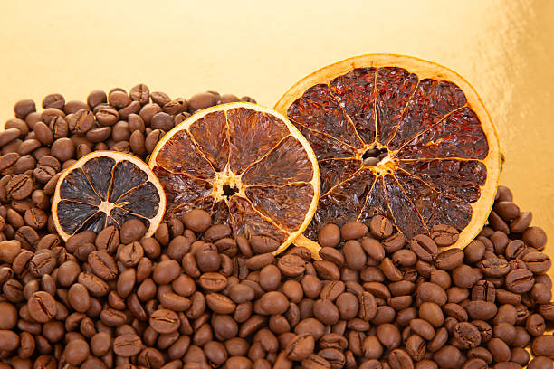 istock Rustic still life featuring dried orange segments scattered over a bed of rich, roasted coffee beans. coffee aroma and taste descriptors 2214418728