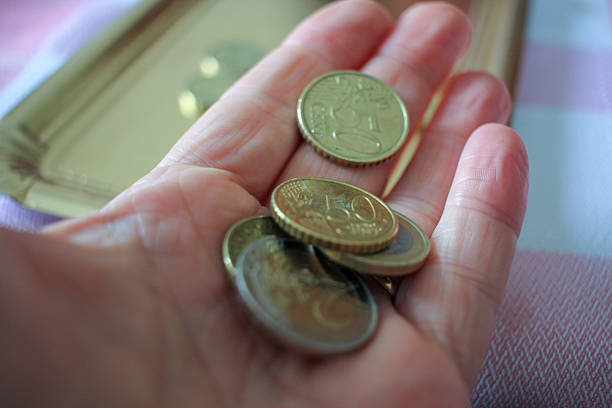 istock change in my hand to pay for a gift 2214420284