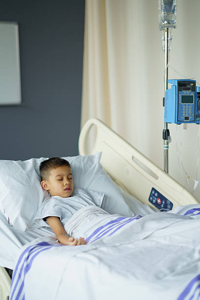 istock Young Child Resting Peacefully in a Modern Hospital Bed 2214422350