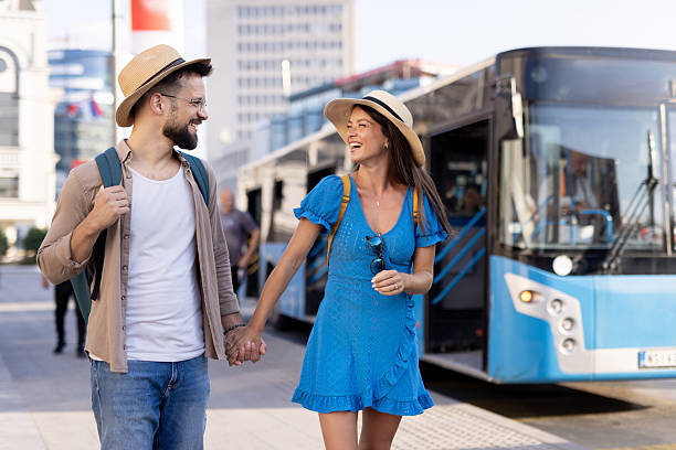 istock Couple holding hands passing a bus reflects joy and youth 2214422941