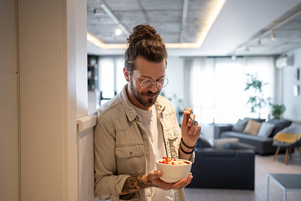 istock Young man enjoying a healthy breakfast at home 2214424086