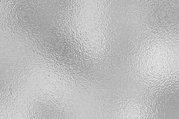 istock Silver gray foil texture glass effect background, gray platinum metallic texture. Silver gradient background. Foil paper, glitter effect. Chrome metal gray pattern. Gradation noise texture 2214430749