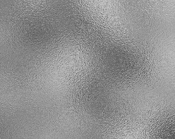istock Silver gray foil texture glass effect background, gray platinum metallic texture. Silver gradient background. Foil paper, glitter effect. Chrome metal gray pattern. Gradation noise texture 2214431334