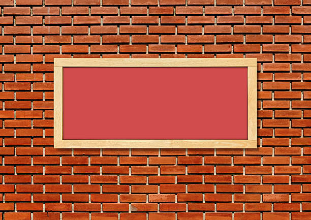 Blank sign on a green painted brick Wall