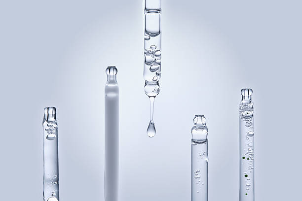 Five different droppers with facial serum in a row.