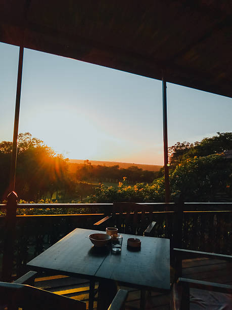 istock Scenic sunset view from a wooden terrace with dining table 2214441061
