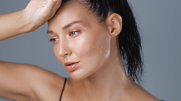 istock Tired Woman Touching Forehead with Wet Skin After Intense Workout 2214443728