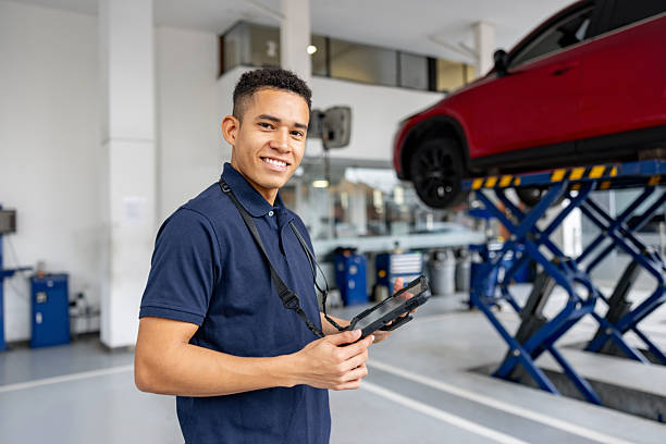 istock Mechanic working at a car garage and holding a digital tablet 2214445634