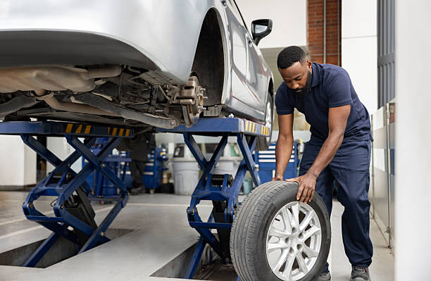 istock Mechanic changing a flat tire on a car at a garage 2214445653