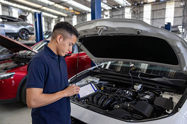 istock Mechanic using a scanner to diagnose the problem with a modern car at the garage 2214445670