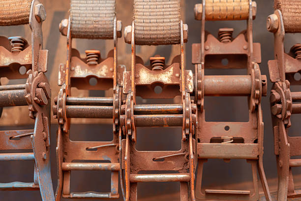 Cargo strap belt and handle part, the equipment that using for securing the heavy object on the trailer or truck transportation. Close-up and selective focus at the equipment part.