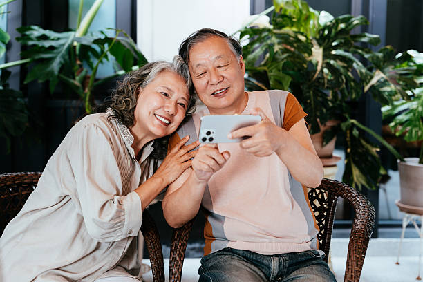 istock Asian senior couple using smart phone in the yard. 2214450415