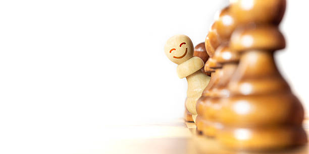 istock Chess pieces engage in playful competition with a smiling pawn standing out prominently during a match 2214452920