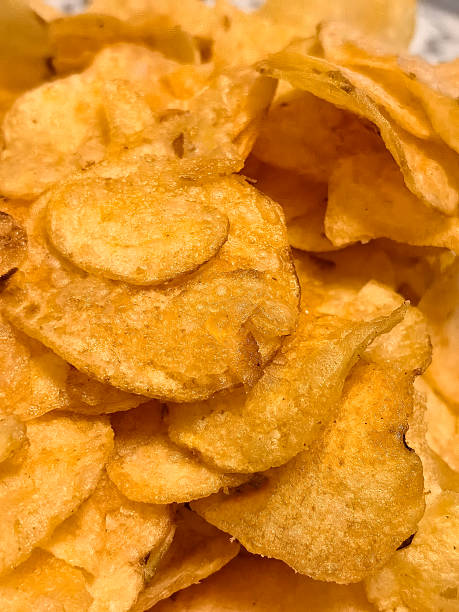 istock Crispy potato chips piled high on a plate, ready for a tasty snack 2214460385