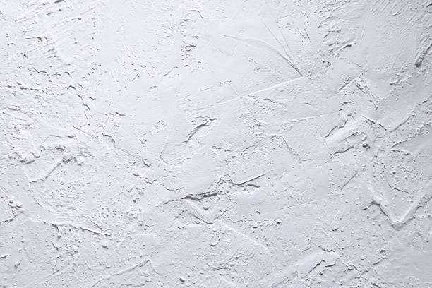 istock White acrylic textured plaster. Drops, lines, arrows, cracks in close-up. Drawing with a spatula 2214461481