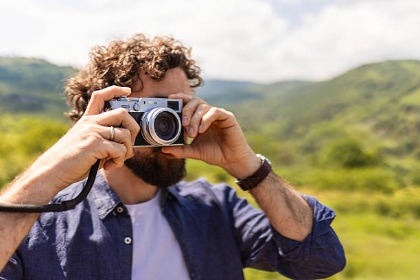 istock Man Taking Photos in Scenic Natural Landscape 2214462445