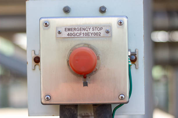 Red emergency stop button close-up on industrial equipment. Safety control switch.