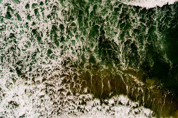 istock Aerial view Top down Waves crashing on sandy shore,Dark sea surface in summer day background,Seascape top view waves at Phuket Thailand 2214465165