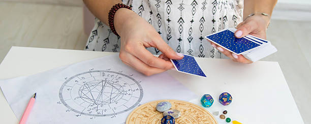 istock A fortune teller reads with tarot cards. Selective focus 2214468207