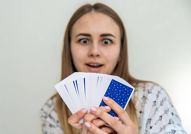 A fortune teller reads with tarot cards. Selective focus.