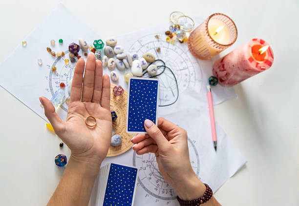 istock A fortune teller reads with tarot cards. Selective focus 2214468224