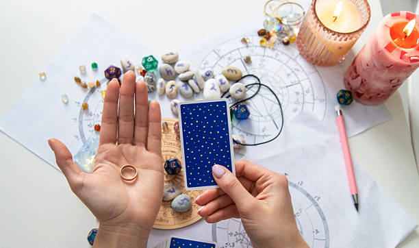 istock A fortune teller reads with tarot cards. Selective focus 2214468225