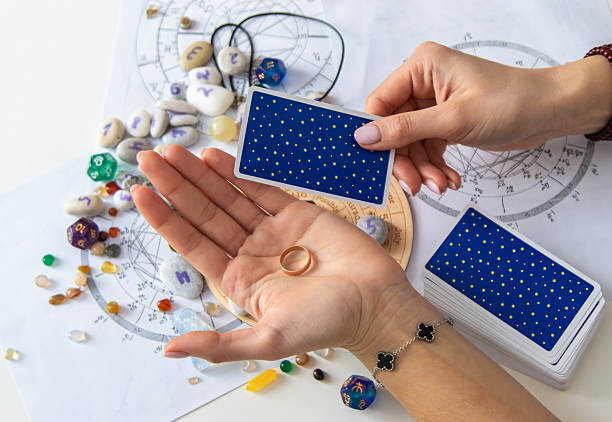istock A fortune teller reads with tarot cards. Selective focus 2214468264