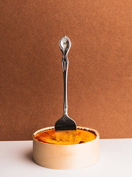 istock Elegant Fork in Creamy Cheesecake on Rustic Brown Background 2214469674