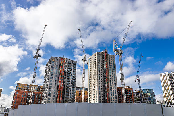 istock Urban high rise construction site with cranes and modern buildings under development 2214471868