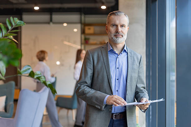 istock Smiling handsome businessman manager standing in office with documents 2214472884
