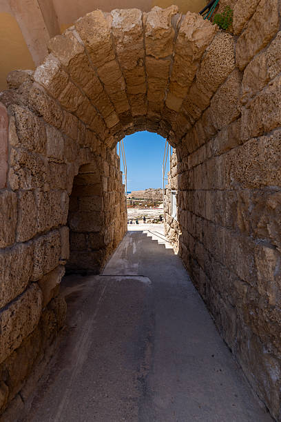 The ancient port and arena with Roman Ruins along the Mediterranean Sea at Caesarea Maritima National Park in Caesarea, Israel. Caesarea is a town on Israel's Mediterranean coast. It’s known for Caesarea National Park, which includes a large Roman amphitheater and the historic port.