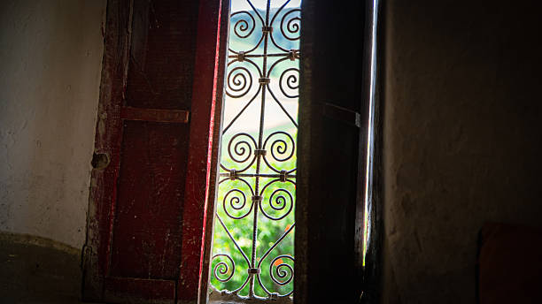 istock Moroccan wrought iron window glimpsed through worn red shutters 2214474148