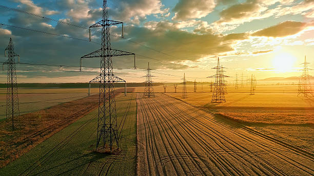istock Power lines stretch across fields, connecting distant towers. 2214474688