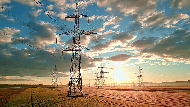 Power lines stretch across fields, connecting distant towers.