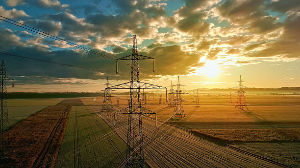 istock Power grid towers over fields at sunset, showcasing energy infrastructure. 2214474693