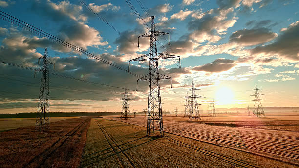 istock Power lines stretch across fields, connecting distant towers. 2214474698
