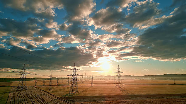 istock Power lines stretch across fields, connecting distant towers. 2214474699