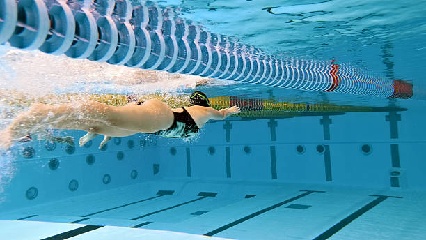 istock Swimmer glides underwater in pool, training for race. 2214474896