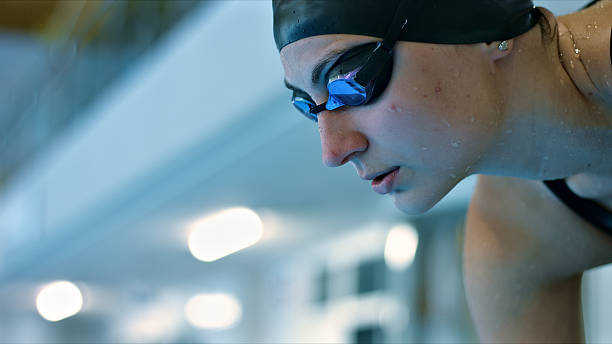istock Swimmer in goggles, focused on training in indoor pool. 2214474948