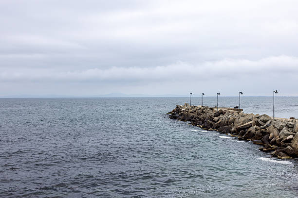istock Bulgarian breakwater with sea under cloudy sky 2214477850