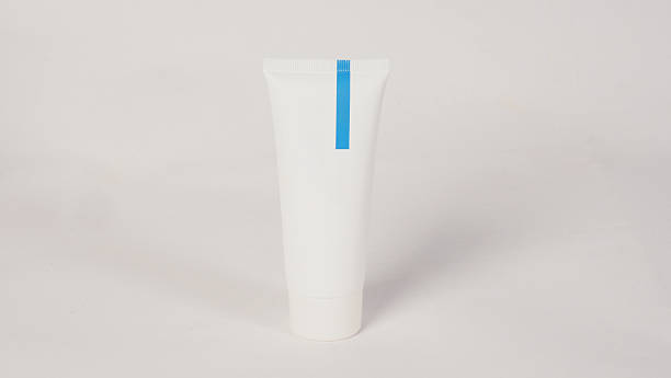 istock a plain white cosmetic tube with a blue vertical stripe on a white background. 2214481482