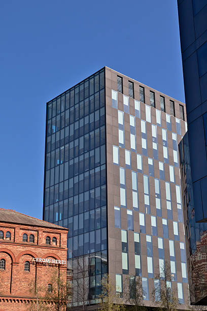 istock Tall Modern Building and Brick Building Under Blue Sky in Liverpool, UK. 2214485482